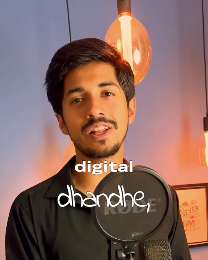 Umer recording a video at a studio microphone